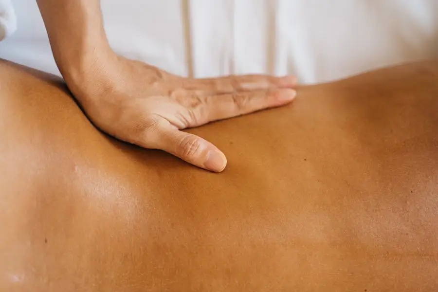 Close-up of hand performing a soothing back massage at a spa.